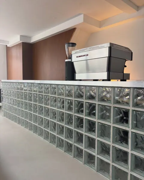 The espresso machine on the glass-block bar