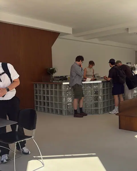 Guests standing at the glass-block bar