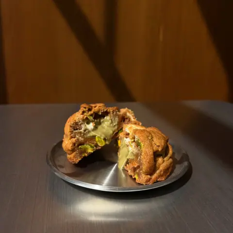 Pistachio white chocolate cookie on a steel plate